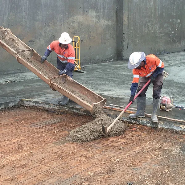 Juwest crew pouring concrete down a chute