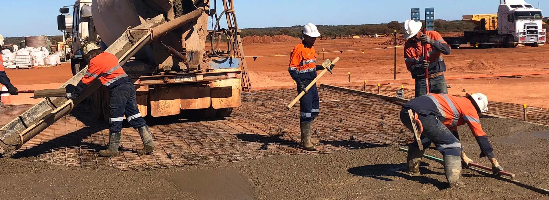 Juwest crew placing and screeding concrete on a remote site